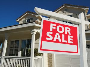 For Sale sign in front of home