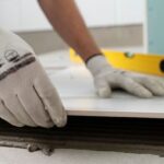 A worker's hands in a fixer upper home